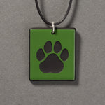 Sandcarved green and black glass cat paw pendant.