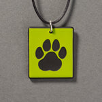 Sandcarved lime green and black glass cat paw pendant.