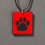 Sandcarved red and black glass cat paw pendant.