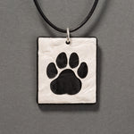 Sandcarved silver pearl and black glass cat paw pendant.