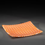 Sandcarved bright orange and white glass circle party plate.