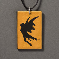 Sandcarved gold and black glass fairy pendant.