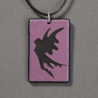 Sandcarved purple and black glass fairy pendant.