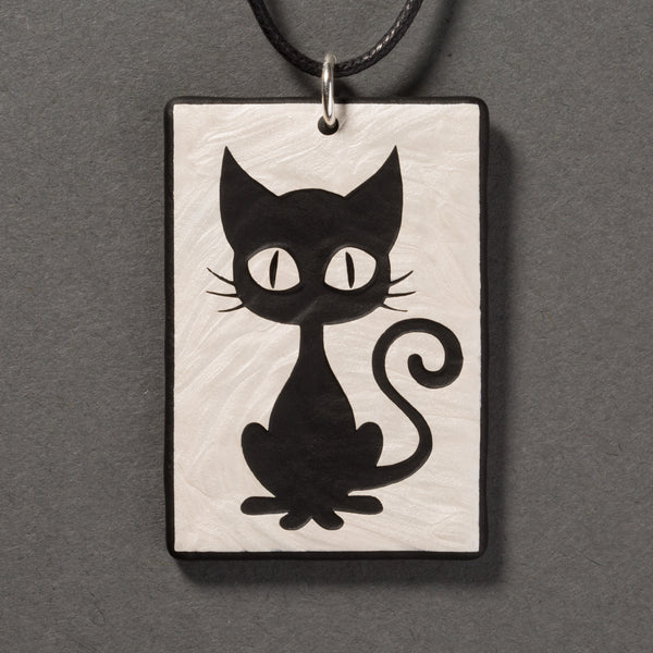 Sandcarved silver pearl and black glass kitty pendant.