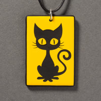 Sandcarved yellow and black glass kitty pendant.