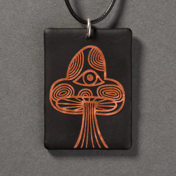 Sandcarved copper and black glass mushroom pendant.