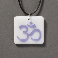 Sandcarved amethyst and white glass om pendant.