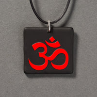 Sandcarved red and black glass om pendant.