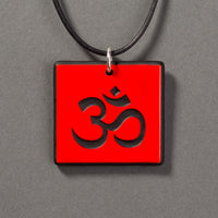 Sandcarved red and black glass om pendant.