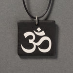 Sandcarved silver pearl and black glass om pendant.