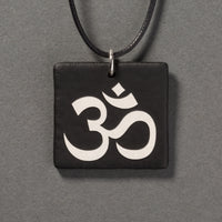 Sandcarved silver pearl and black glass om pendant.