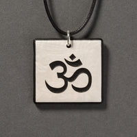 Sandcarved silver pearl and black glass om pendant.