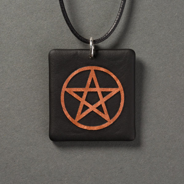 Sandcarved copper and black glass pentacle pendant.