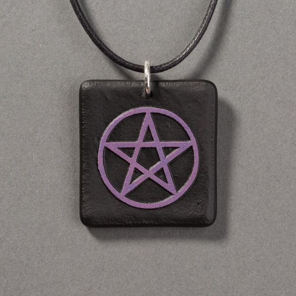 Sandcarved purple and black glass pentacle pendant.