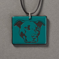 Sandcarved aquamarine and black glass pit bull pendant.