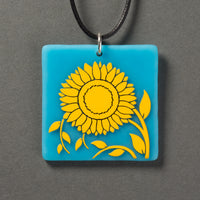 Sandcarved yellow and cyan glass sunflower pendant.