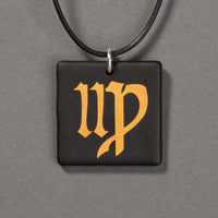 Sandcarved gold and black glass virgo pendant.