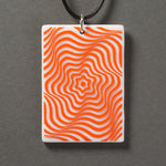 Sandcarved bright orange and white glass vortex pendant.