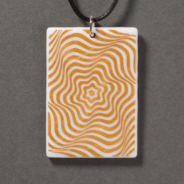 Sandcarved gold and white glass vortex pendant.