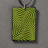 Sandcarved lime green and black glass vortex pendant.