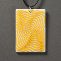 Sandcarved yellow and white glass vortex pendant.