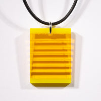 Cut and polished yellow glass layer pendant.